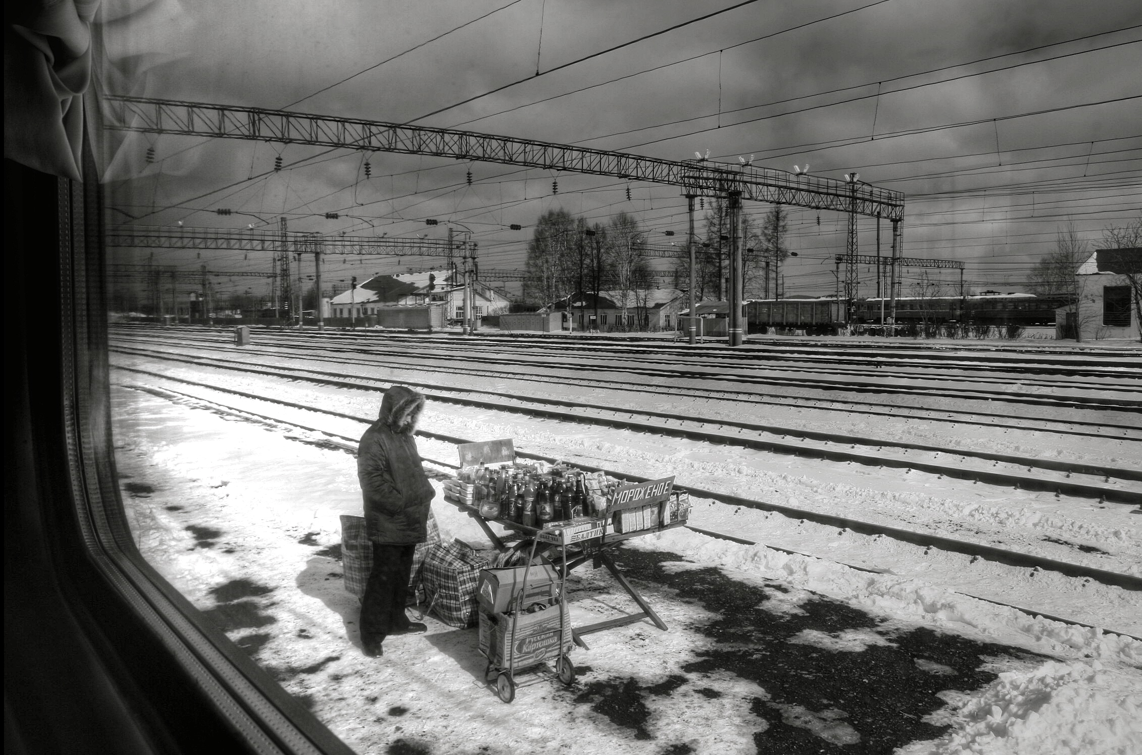 The train trundles past small villages and dachas and then stops in a cacophony as people run down the carriages selling toys, beer, dried fish, meat pies and ice cream.